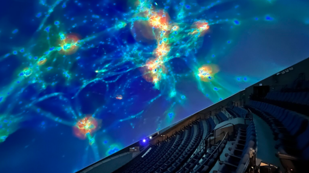  Inside MOSI’s eight-story-tall blue dome with a 10,000-square-foot curved screen displaying immersive visuals.