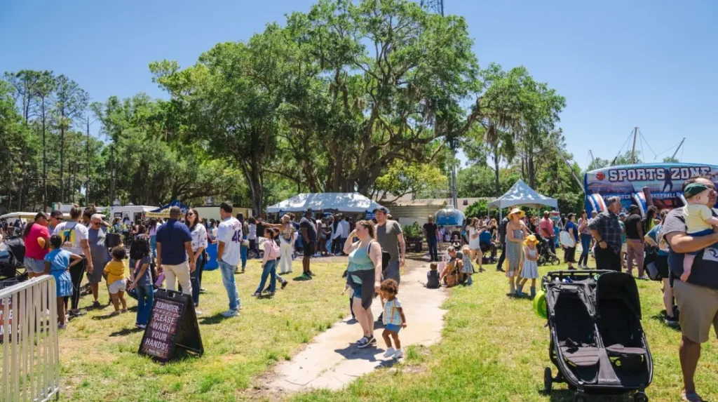 Visitors enjoying blueberry cider and food truck dishes at the Keel Farms festival