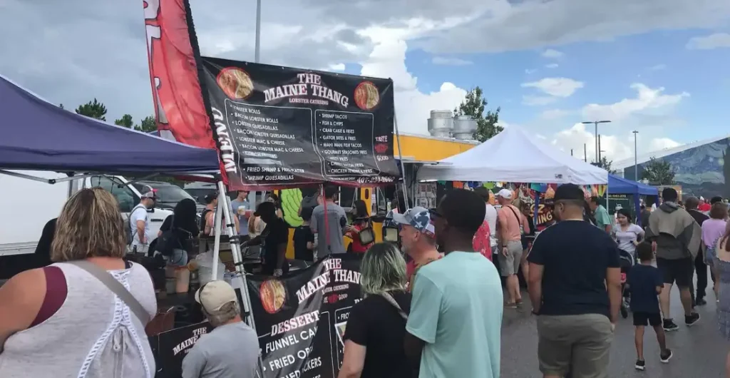 A family enjoying tacos and burgers at Tampa's International Food Truck Festival 5.0