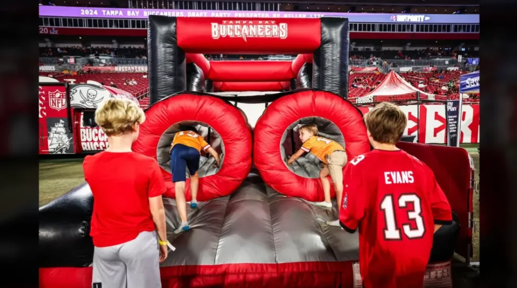 Two young fans holding Buccaneers flags during the NFL Draft Party