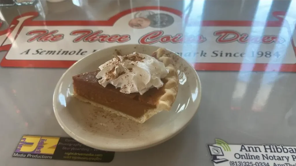 Night view of Three Coins Diner lit up in Tampa