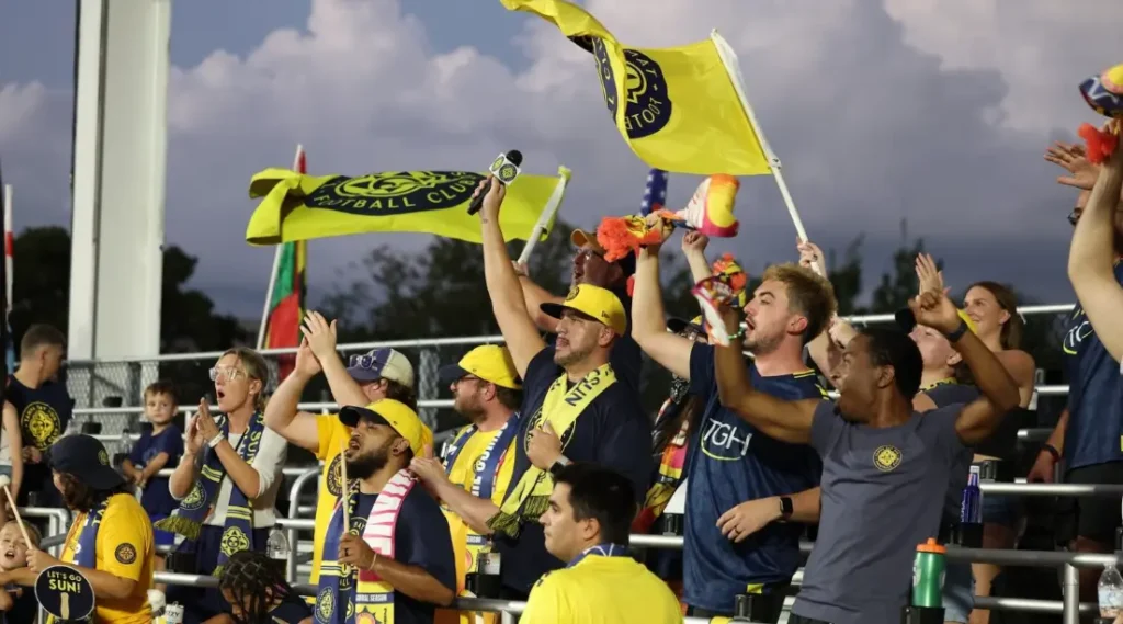  Tampa Bay Sun FC players holding USL Super League trophy on boat during Hillsborough River parade
