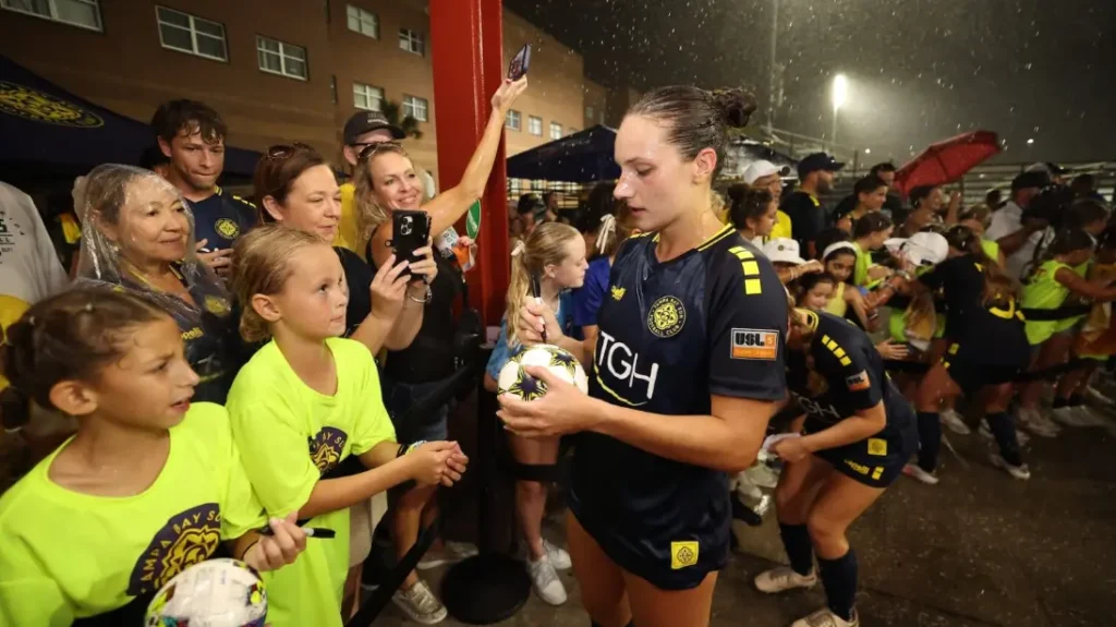 Tampa Bay Sun fans celebrating at Armature Works Pier during championship parade